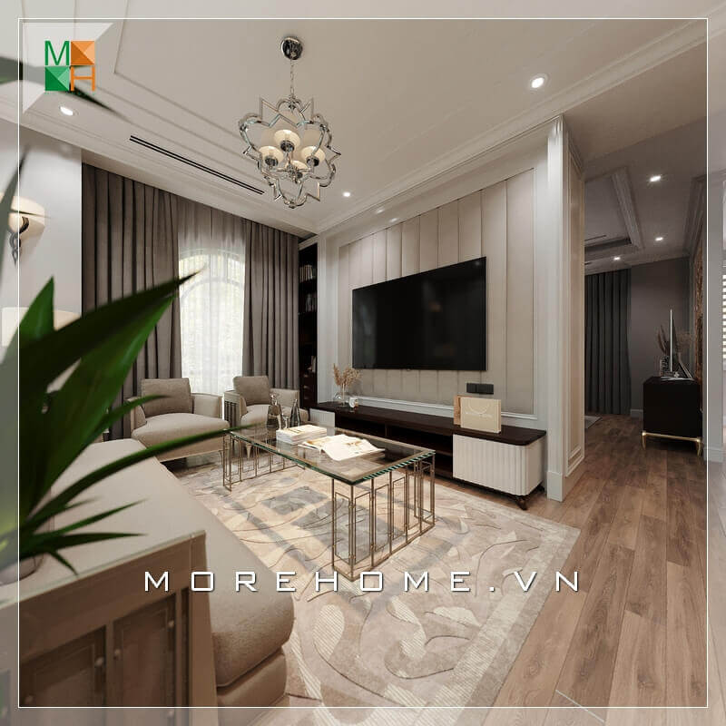 Trong thiết kế nội thất phòng khách chung cư tân cổ điển kết hợp hiện đại, có rất nhiều người lựa chọn ghế sofa làm điểm nhấn trang trí. Ghế sofa vải đem lại sự hài hòa, trang nhã cũng như giá thành hợp lý. Bên cạnh đó, kệ TV cũng là một điểm đáng lưu ý khi trang trí phòng khách. Kệ TV thường được làm bằng gỗ công nghiệp cao cấp An Cường đảm bảo tính bền bỉ và đẹp. Thiết kế mảng tường treo của TV rất ấn tượng với những cái phào nổi đúng chất phong cách tân cổ điển.